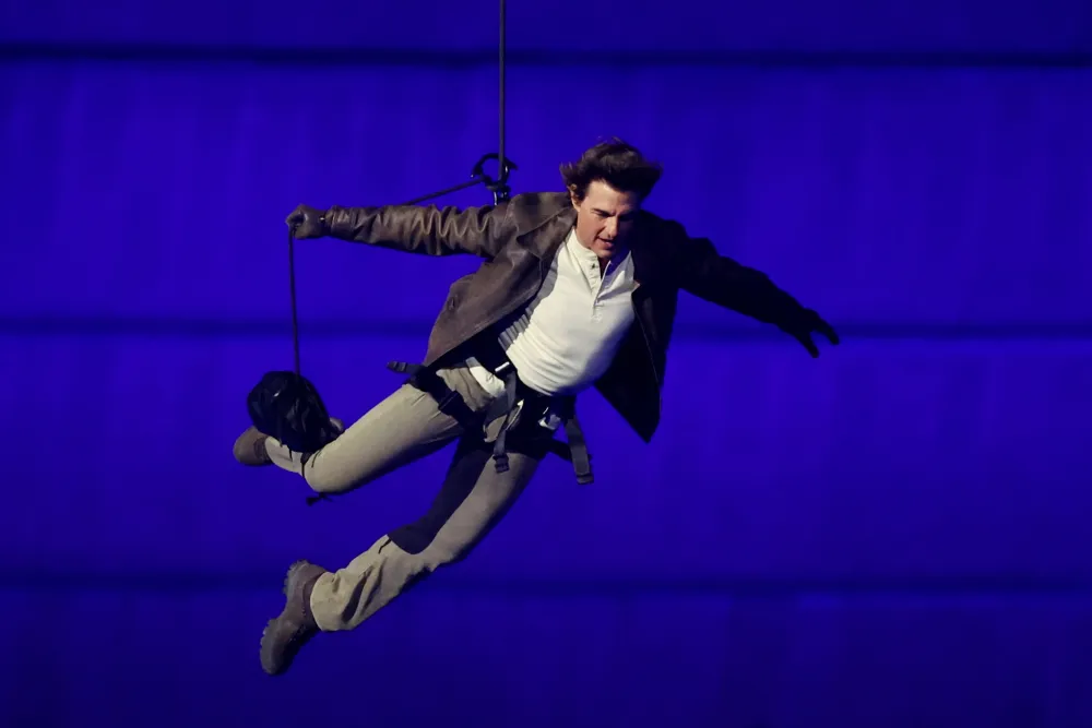 Tom Cruise Dives Into Olympics Closing Ceremony, Drives Off With Flag To LA 2028