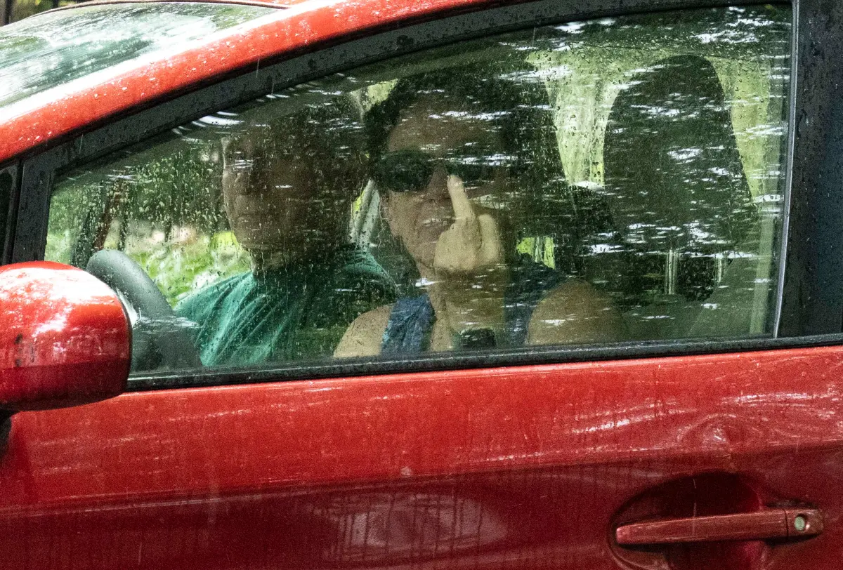 Miserable Fauci Spotted Taking Out Trash, Pissed Off Wife Flips Off Camera